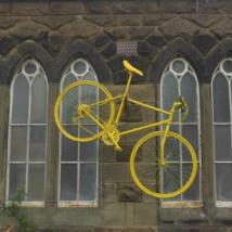A yellow bike hanging on a wall - a blog post by Sarah Maidment Interiors, interior designer, Berkhamsted, St. Albans, Hertfordshire